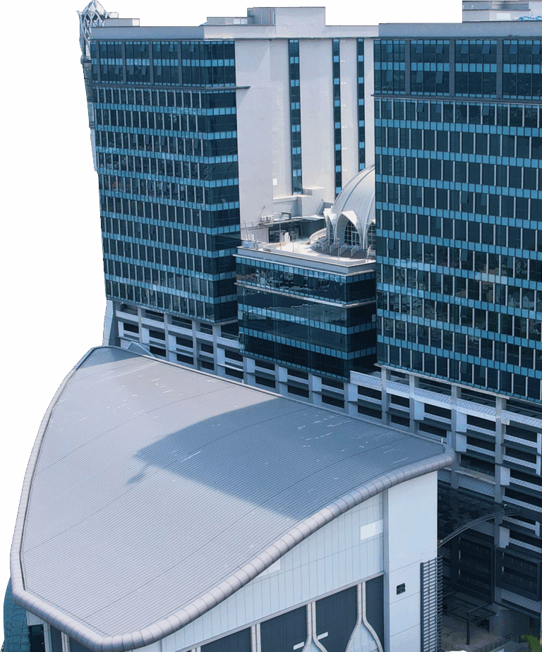 Modern glass high-rise with curved rooftop and domed atrium, set against black background